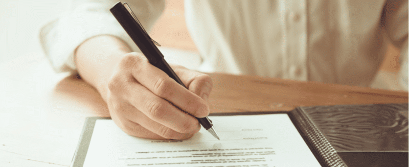 Signing documents to transfer ownership of a home