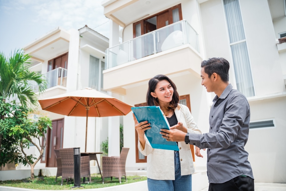 Two people discussing a contract to buy a co-op