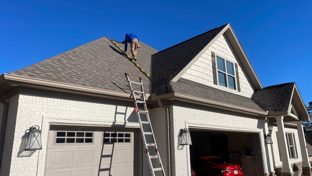 Home inspector climbing on the roof