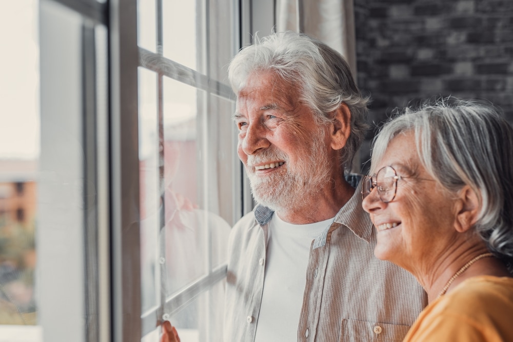 Couple looks out the window as they discuss holding title as tenants in common