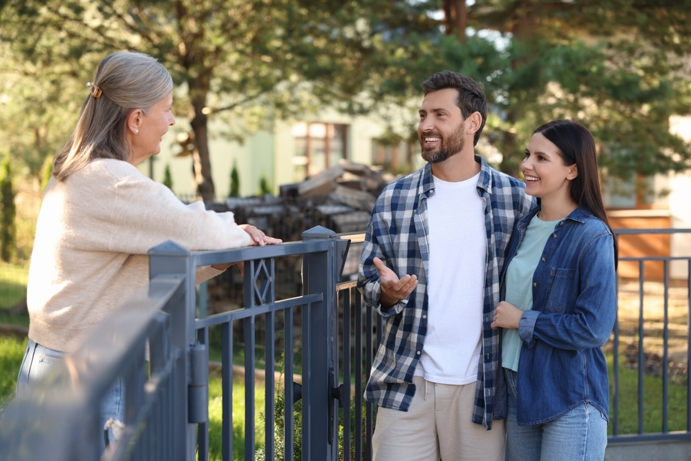 Neighbors getting to know one another over a fence