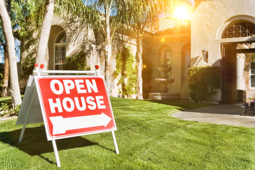 Home is listed for sale and has an open house sign in front of it