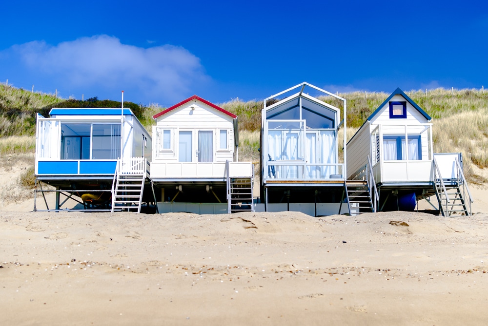 Four beach houses on a white sand beach