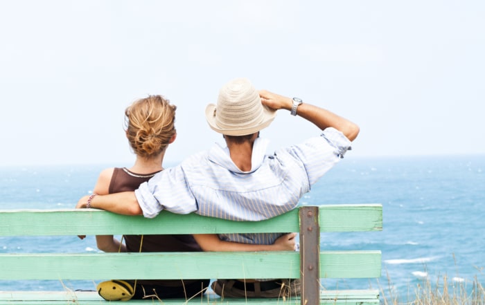 husband and wife looking out at the ocean